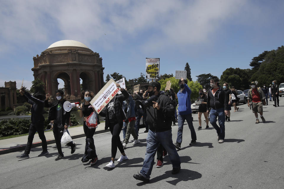 Marchers walk in front of the Palace of Fine Arts in the Marina District during a protest calling for an end to racial injustice and accountability for police in San Francisco, Sunday, June 21, 2020. (AP Photo/Jeff Chiu)