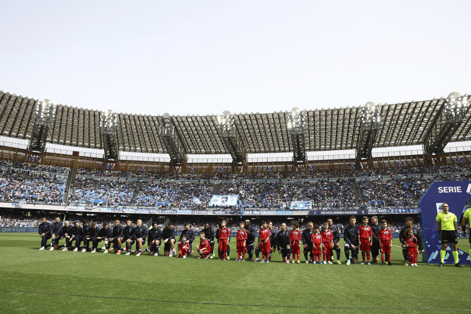 Napoli team players take the knee ahead of the Serie A soccer match between Napoli and Atalanta at the Diego Armando Maradona Stadium in Naples, Italy, Saturday, March 30, 2024. Napoli defender Juan Jesus says he has been left feeling “very bitter” and “crestfallen” by the Italian league’s decision not to punish Inter Milan player Francesco Acerbi for an allegedly racist remark toward him. (Alessandro Garofalo/LaPresse via AP)