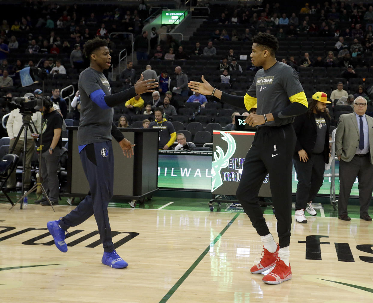 Milwaukee Bucks' Giannis Antetokounmpo, right, and Dallas Mavericks' Kostas Antetokounmpo, left, greet at midcourt before an NBA basketball game Monday, Jan. 21, 2019, in Milwaukee. (AP Photo/Aaron Gash)