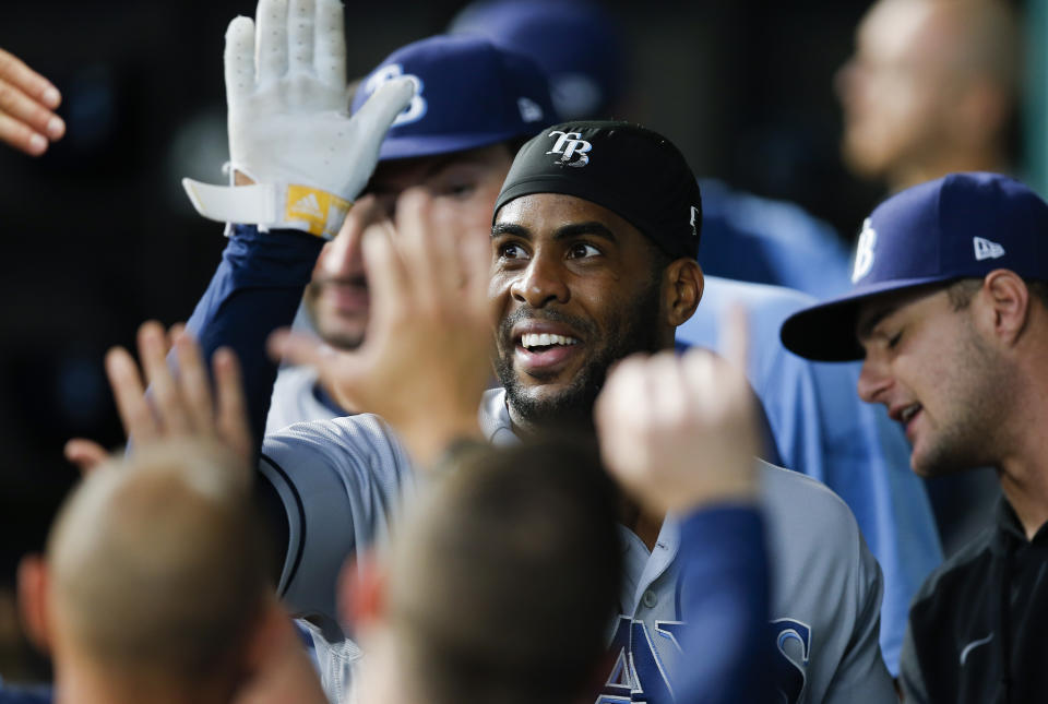 Tampa Bay Rays' Yandy Diaz (2) is congratulated by teammates after scoring on a two-RBI single hit by Austin Meadows during the first inning of a baseball game against the Texas Rangers, Saturday, June 5, 2021, in Arlington, Texas. (AP Photo/Brandon Wade)