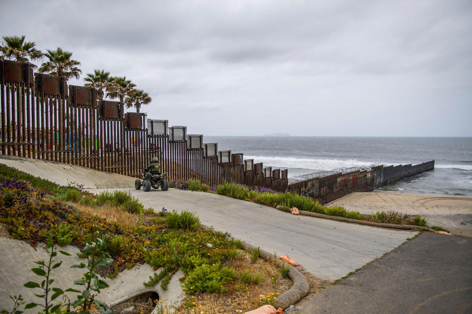 A U.S. Border Patrol agent drives an all-terrain vehicle as the border wall ends in the Pacific Ocean along the U.S.-Mexico border between San Diego and Tijuana, on May 10, 2021 at International Friendship Park in San Diego County, Calif. (Patrick T. Fallon / AFP via Getty Images file)