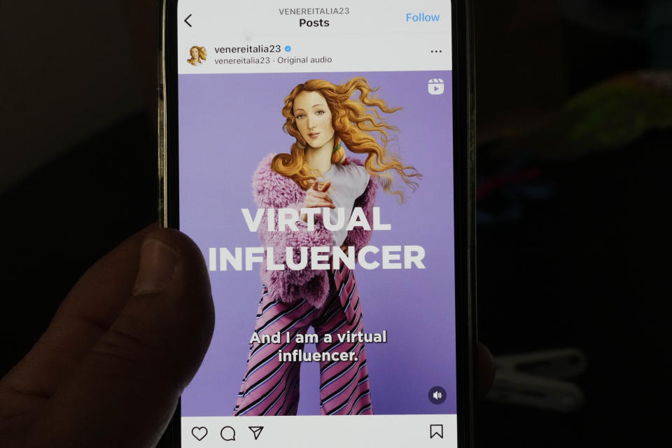 A man watches the latest Italian Ministry of Tourism nine-million-euro campaign showing Botticelli's Venus depicted as a virtual influencer on his smartphone in Rome, Wednesday, May 3, 203. A nine-million-euro advertising campaign by Italy’s conservative government that has transformed “The Birth of Venus,” painted by Renaissance master Sandro Botticelli in Florence around 1485, into a virtual influencer has met with widespread derision. (AP Photo/Gregorio Borgia)