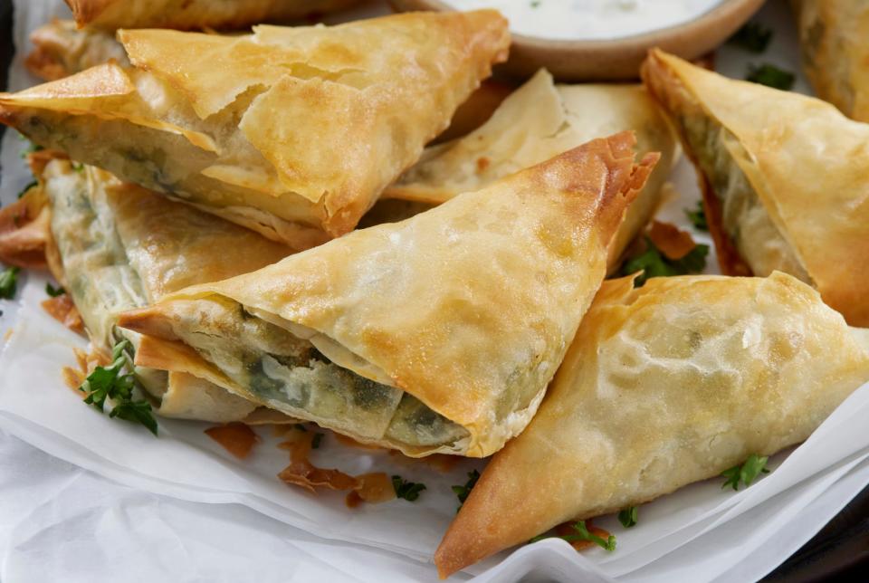Spanakopita is a savory Greek pie made with spinach and cheese wrapped in phyllo dough.