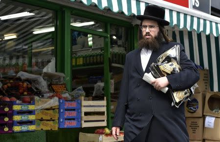 An orthodox Jewish man walks through a street in Stamford Hill north London, Britain May 3, 2016. REUTERS/Hannah McKay