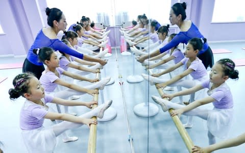 Children of Yugur ethnic minority learn traditional dance in Zhangye, northwest China's Gansu Province - Credit: Wang Jiang/Zuma Press / eyevine