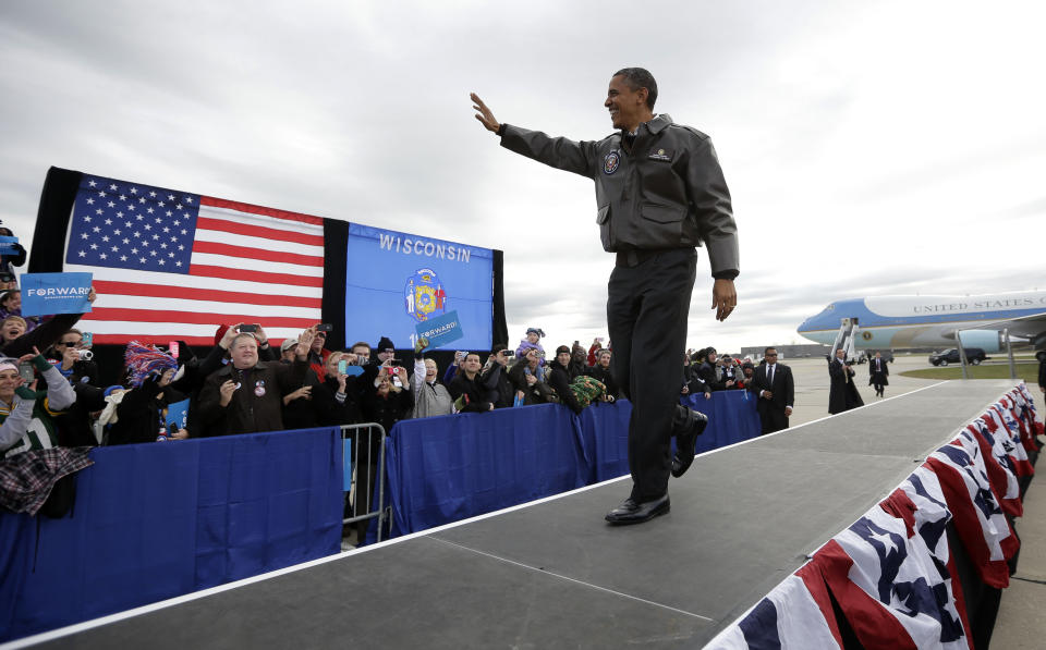 President Barack Obama waves to supporters as he walks on stage for a campaign event at Austin Straubel International Airport in Green Bay, Wis.,Thursday, Nov. 1, 2012. Obama resumed his presidential campaign with travel to key background states of Wisconsin, Colorado, Nevada and Ohio today. (AP Photo/Pablo Martinez Monsivais)