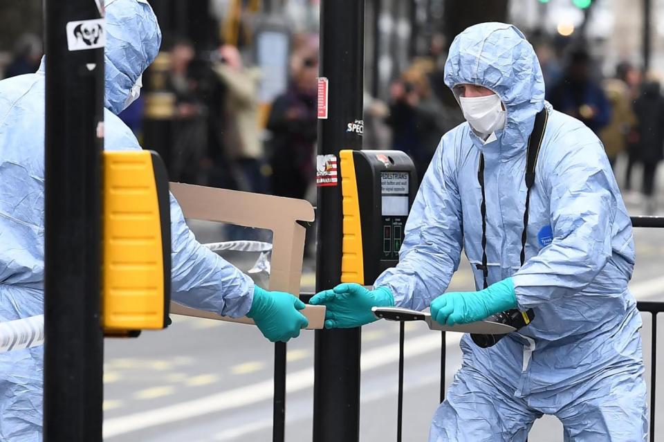 Forensic officials inspecting the seized weapons (AFP/Getty Images)