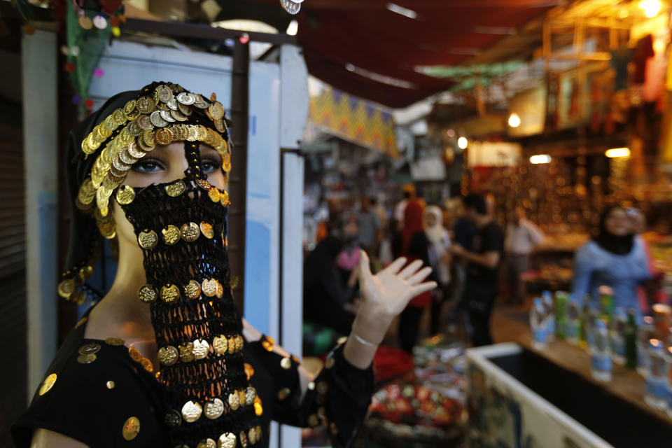A headdress adorns a mannequin in the Khan El-Khalili market, normally a popular tourist destination, in Cairo, Egypt, Monday, Sept. 9, 2013. Before the 2011 revolution that started Egypt's political roller coaster, sites like the pyramids were often overcrowded with visitors and vendors, but after a summer of coup, protests and massacres, most tourist attractions are virtually deserted to the point of being serene. (AP Photo/Lefteris Pitarakis)