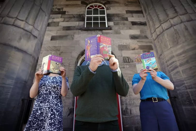 Lyon & Turnbull of people holding Harry Potter books.