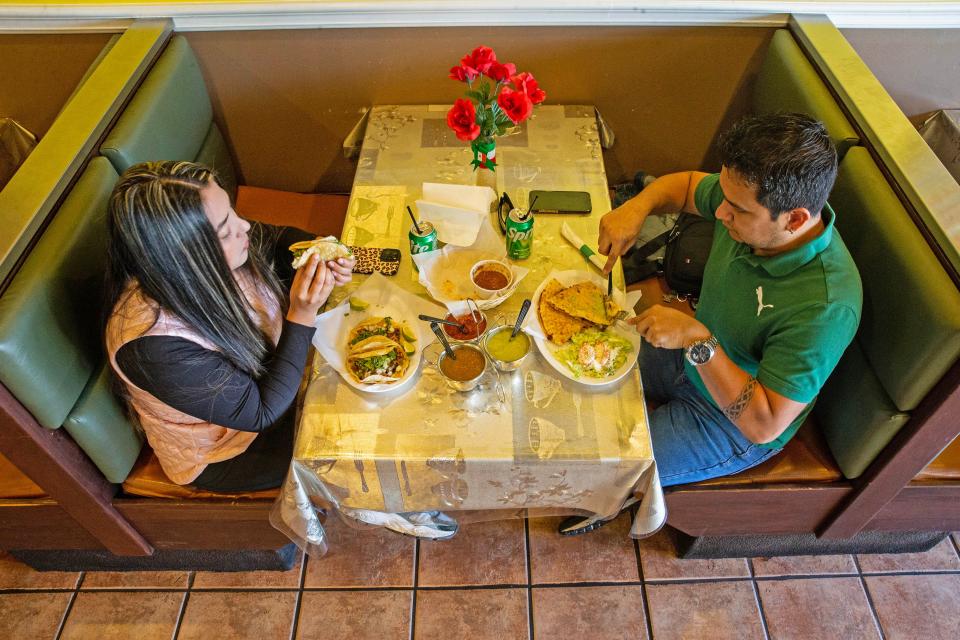Patrons Carla Macabeo and Cesar Guerrero dine on "carnitas" tacos and quesadillas at Tortilleria Dos Milpas in Elsmere, Tuesday, Oct. 24, 2023. Dos Milpas makes tortillas from nixtamalized corn, with Michoacan-style carnitas, and is part of the reason why northern Delaware is deemed to have some of the best Mexican food in the region.