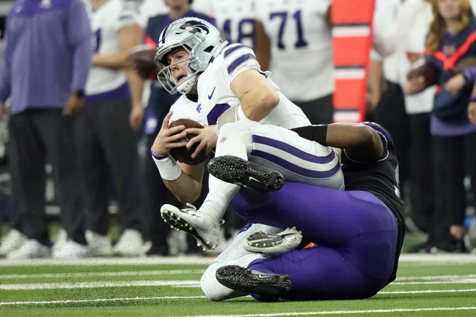 TCU defensive lineman Dylan Horton (98) sacks Kansas State quarterback Will Howard (18) in the first half of the Big 12 Conference championship NCAA college football game, Saturday, Dec. 3, 2022, in Arlington, Texas. (AP Photo/LM Otero)