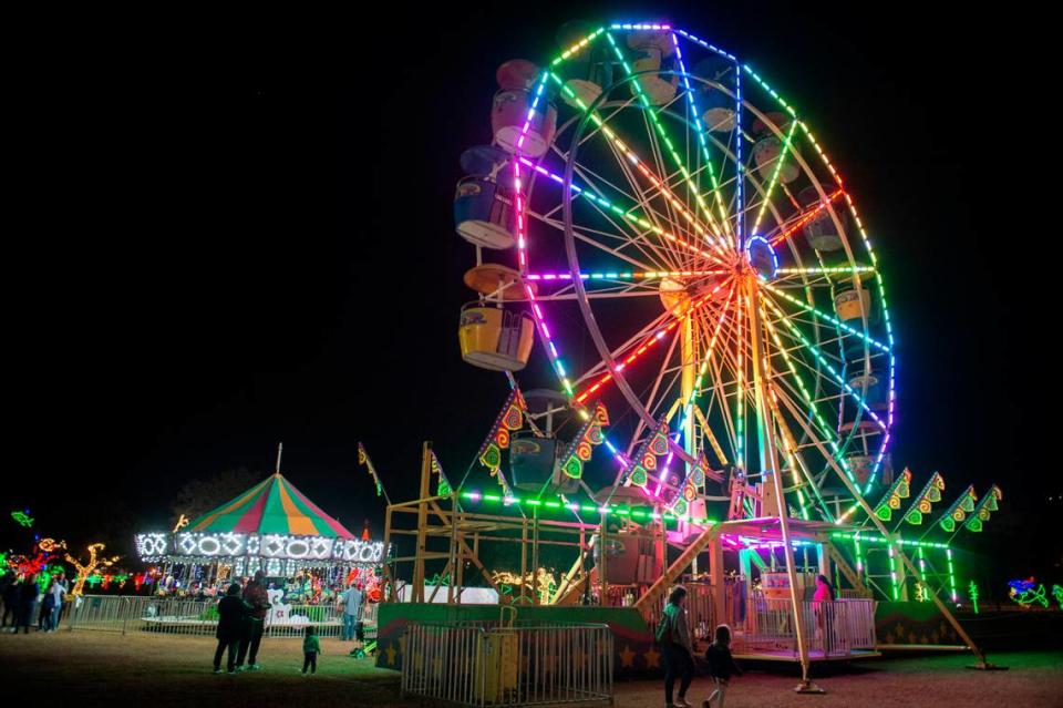 The merry-go-round and Ferris wheel add to the 1.5 million lights at Harbor Lights Winter Festival at Jones Park in Gulfport