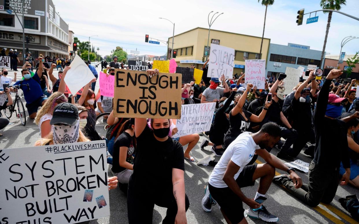 Protesters gather in Los Angeles over the death of George Floyd, but fears persist that a lack of social distancing will lead to a fresh outbreak of the novel coronavirus - ROBYN BECK/AFP