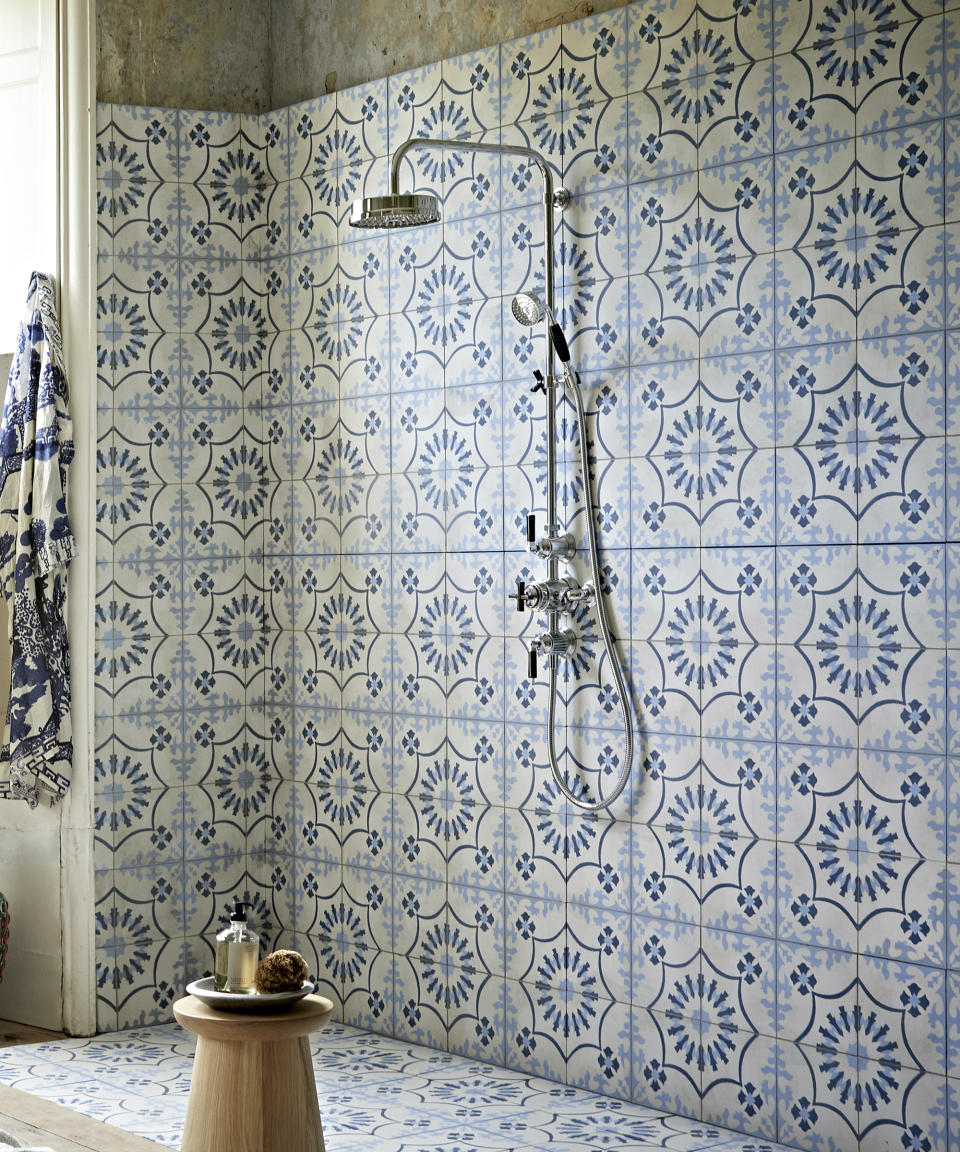 A shower with matching floor and wall tiles