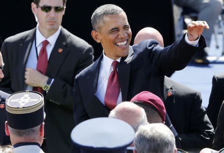 U.S. President Barack Obama waves while participating in the 70th French-American Commemoration D-Day Ceremony at the Normandy American Cemetery and Memorial in Colleville-sur-Mer June 6, 2014. REUTERS/Pascal Rossignol
