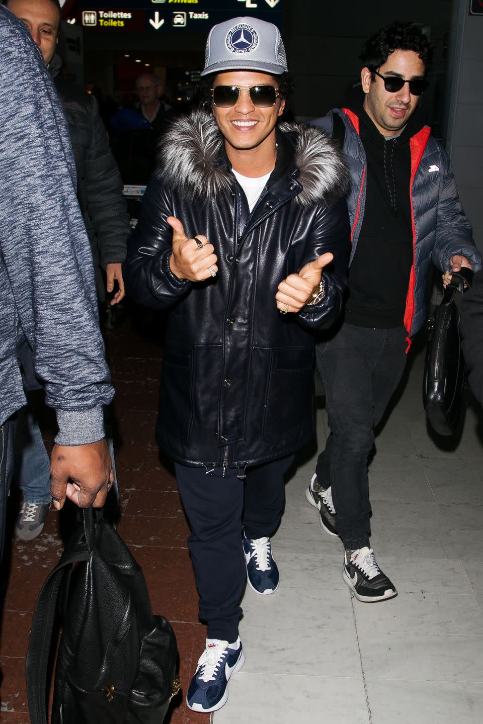 <p>A Mercedes Benz hat. A leather winter coat over (essentially) sweatpants. And sunglasses, at night. What's not to love? </p>