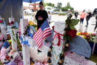 Crosses at a makeshift memorial by the mall where several people were killed show several messages left by those who have visited the memorial, Wednesday, May 10, 2023, in Allen, Texas. (AP Photo/Tony Gutierrez)