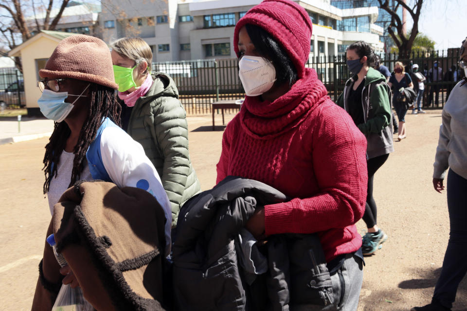 Tsitsi Dangerembga, left, prominent Zimbabwean author and Fadzayi Mahere, right, spokeswoman for the main opposition party, appear at the magistrates courts with others in Harare, Saturday, Aug, 1, 2020. Police arrested scores of people in Harare and other towns in Friday's protests according to the Zimbabwe Lawyers for Human Rights. (AP Photo/Tsvangirayi Mukwazhi)