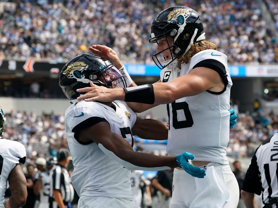 Trevor Lawrence celebrates with Zay Jones after a touchdown against the Los Angeles Chargers.