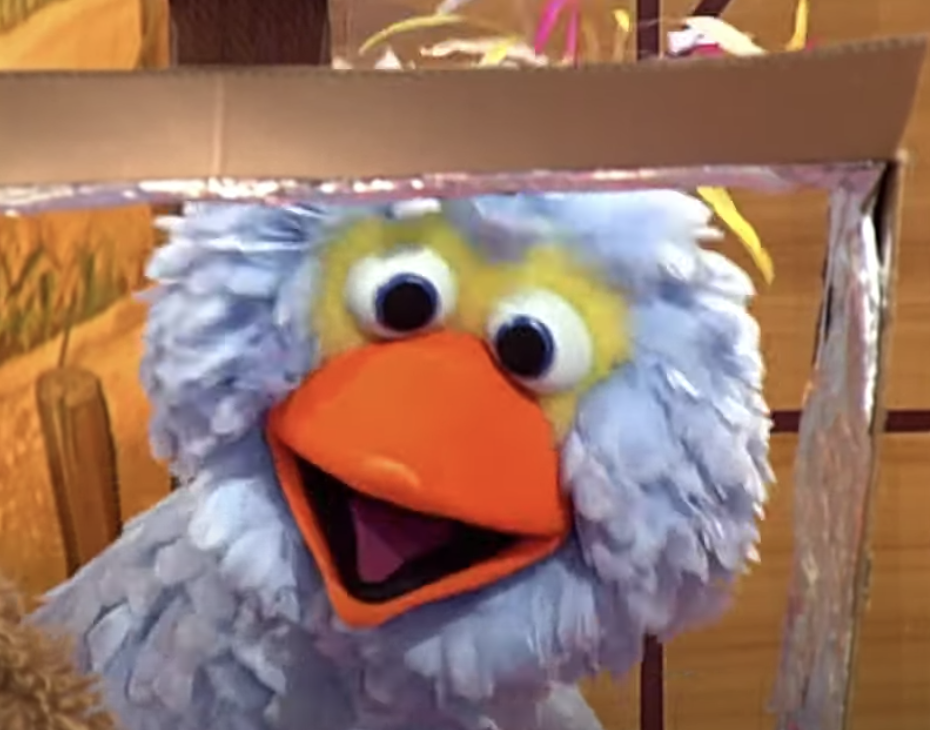 a light blue Big Bird looks at the screen