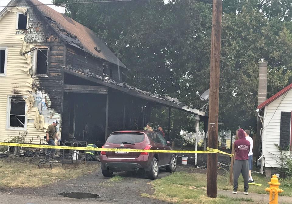 Fire investigators sift through the damage at 726 Hopkins St. in the Town of Southport, which was heavily damaged by flames early Monday, June 12, 2023.
