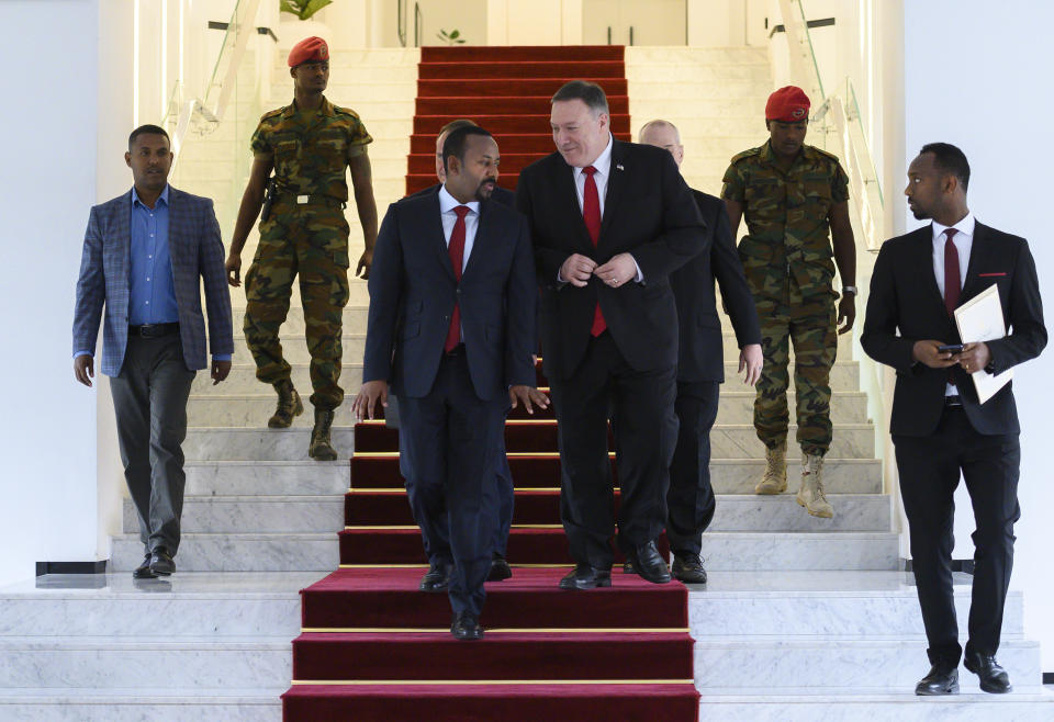 FILE - In this Tuesday, Feb. 18, 2020 file photo, U.S. Secretary of State Mike Pompeo, center right, walks with Ethiopia's Prime Minister Abiy Ahmed, center-left, after meeting at the Prime Minister's office in Addis Ababa. The State Department said Wednesday, Sept. 2, 2020 that on the guidance of President Donald Trump the U.S. is suspending some aid to Ethiopia over the "lack of progress" in talks with Egypt and Sudan over a massive, disputed dam project which Egypt has called an existential threat and worries will reduce the country's share of Nile waters. (Andrew Caballero-Reynolds/Pool via AP, File)