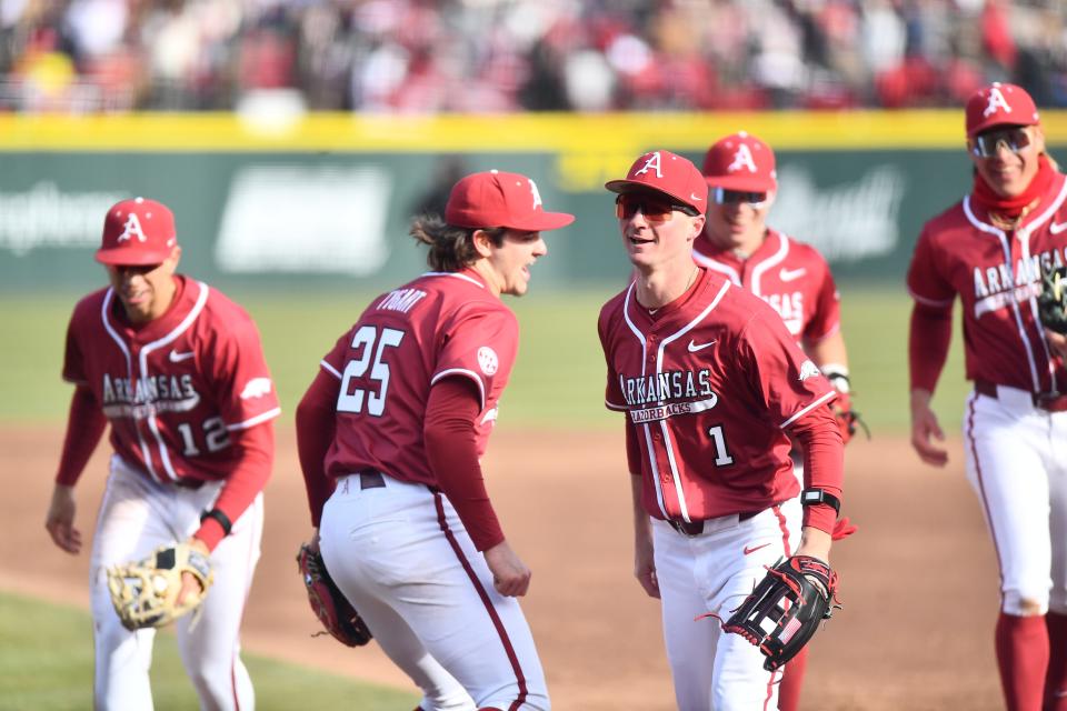 Arkansas center fielder Ty Wilmsmeyer (1) celebrates with pitcher Brady Tygart after Wilmsmeyer robbed a home run during the Razorbacks 15-5 win over James Madison on Saturday, Feb. 17.