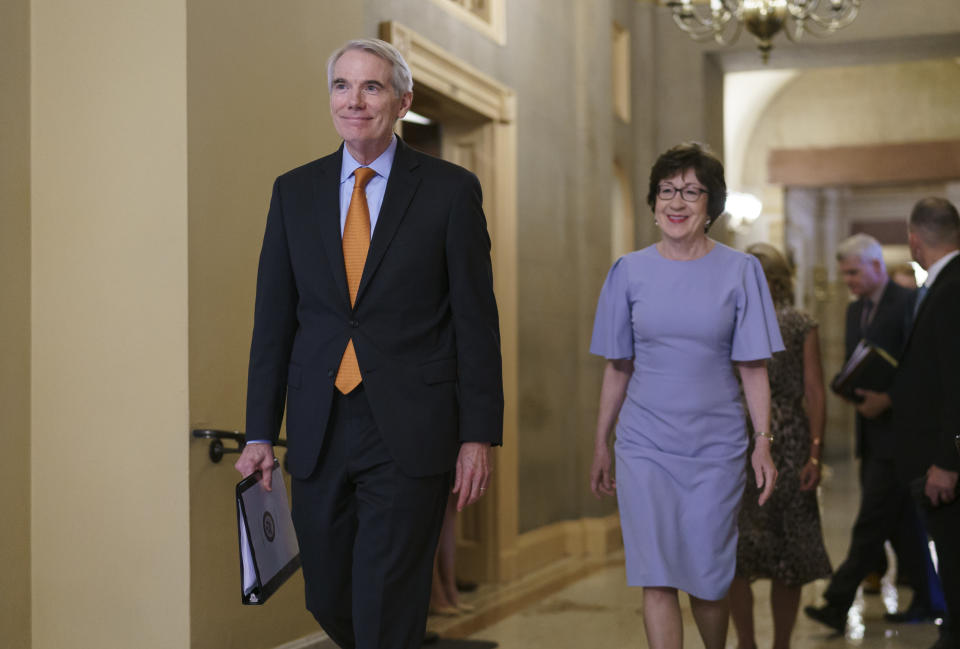 Sen. Rob Portman, R-Ohio, left, and Sen. Susan Collins, R-Maine, smile as they emerge from the office of Senate Republican Leader Mitch McConnell to announce agreement with Democrats on a $1 trillion infrastructure bill and are ready to vote to take up the bill, at the Capitol in Washington, Wednesday, July 28, 2021. (AP Photo/J. Scott Applewhite)