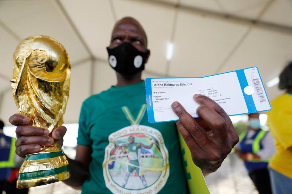 A South African national football team supporter holds his ticket  (AFP via Getty Images)