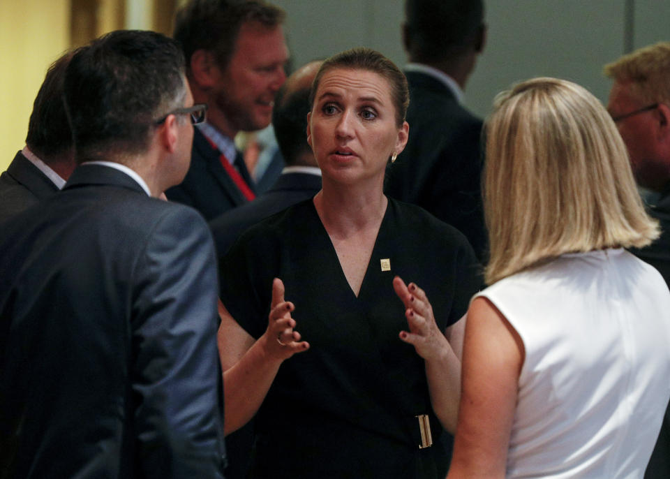 Danish Prime Minister Mette Frederiksen, center, speaks with European Union foreign policy chief Federica Mogherini, right, during a round table meeting at an EU summit in Brussels, Sunday, June 30, 2019. European Union leaders have started another marathon session of talks desperately seeking a breakthrough in a diplomatic fight over who should be picked for a half dozen of jobs at the top of EU institutions. (Geoffroy Van Der Hasselt, Pool Photo via AP)