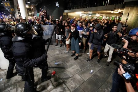 Protesters form barricades as they demonstrate at the airport, after a verdict in a trial over a banned independence referendum, in Barcelona