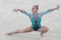 FILE - In this Aug. 2, 2021, file photo, Angelina Melnikova, of the Russian Olympic Committee, performs on the floor during the artistic gymnastics women's apparatus final at the 2020 Summer Olympics in Tokyo, Japan. The 50th artistic gymnastics world championships started Monday, Oct. 18, 2021 and will continue through Sunday in Kitakyushu, featuring more than 300 gymnasts representing 59 countries. (AP Photo/Gregory Bull, File)