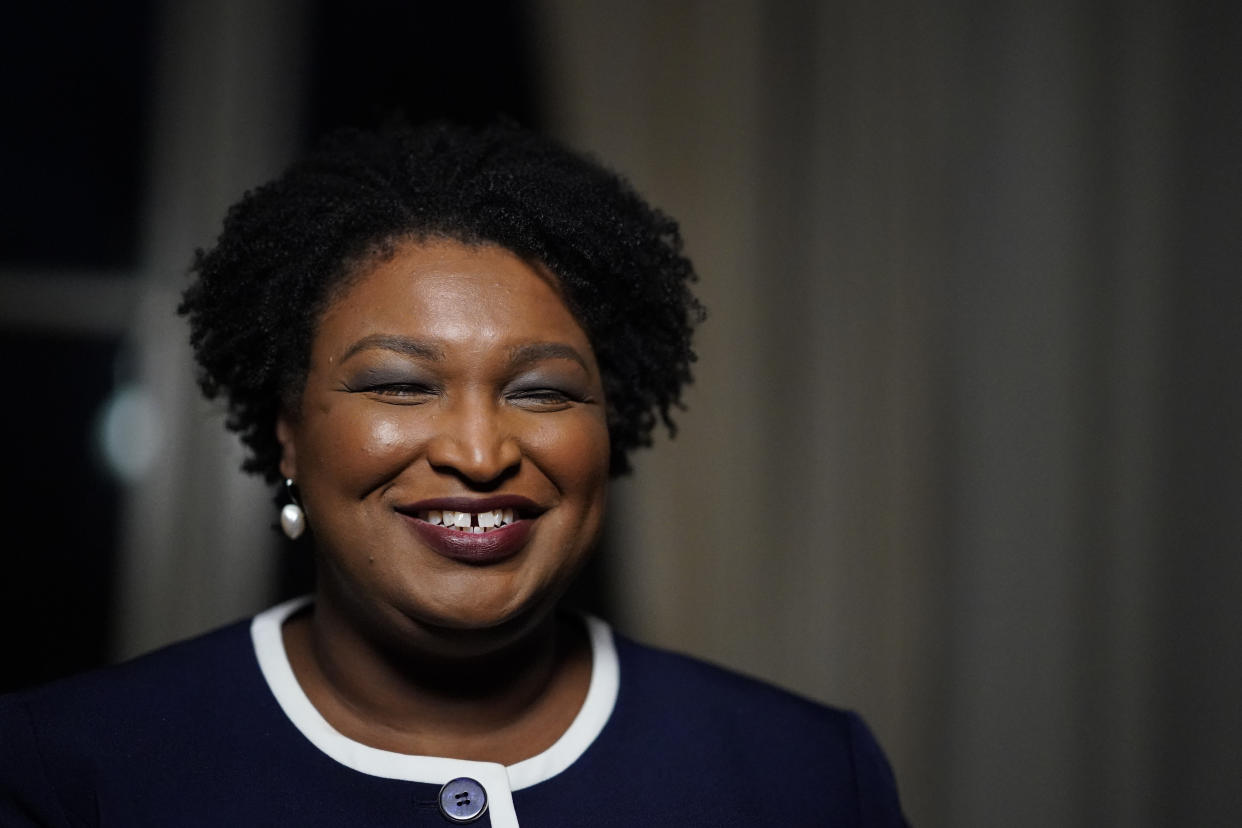 FILE - Then-Georgia gubernatorial Democratic candidate Stacey Abrams speaks during an interview with The Associated Press on Dec. 16, 2021, in Decatur, Ga. Stacey Abrams has used a campaign stop in Atlanta to applaud the push for voting rights in Congress and express support for President Biden. Abrams was noticeably absent from Biden’s visit last week to Atlanta, where he called for an end to the filibuster to pass voting legislation. Abrams said Wednesday, jan. 19, 2022 that she was a proud Democrat and 