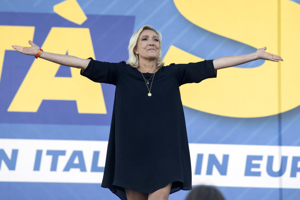 French right-wing leader Marine Le Pen acknowledges supporters as she stands on stage on the occasion of an annual League (Lega) party rally, in Pontida, northern Italy, Sunday, Sept. 17, 2023. (Claudio Furlan/LaPresse via AP)