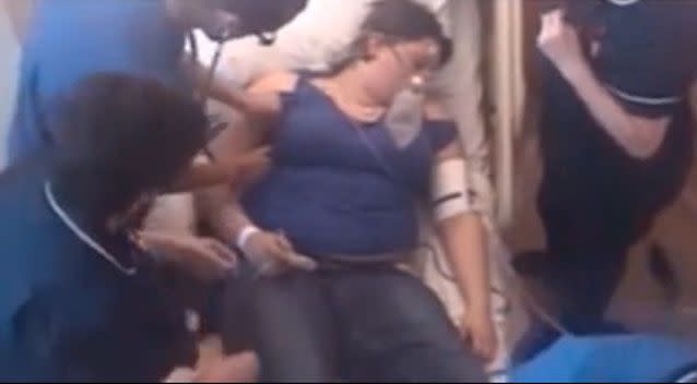 A team of medics desperately work to revive Sara Brautigam who's heart has stopped beating. Photo: YouTube.