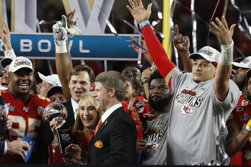 FILE - Kansas City Chiefs owners chairman Clark Hunter, foreground center, and his mother, Norma Hunt, celebrate with quarterback Patrick Mahomes, right, and others after the NFL Super Bowl 54 football game against the San Francisco 49ers in Miami Gardens, Fla., in this Feb. 2, 2020, file photo. The Kansas City Chiefs won 31-20. The matriarch of the Kansas City Chiefs will continue her streak of seeing every Super Bowl in person. Chiefs chairman Clark Hunt says his 82-year-old mother will make the trip to Tampa, Florida, to see Kansas City play the Buccaneers. (AP Photo/Mark Humphrey, File)