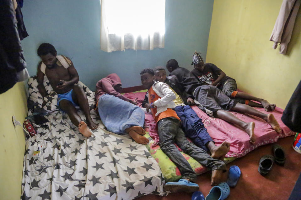 In this photo taken Tuesday, May 28, 2019, LGBT refugees from Burundi, Rwanda and Congo lie on a mattress in one of the rooms they share in the house where they take shelter in a low-income neighborhood of the capital Nairobi, Kenya. LGBT refugees allege they have been harassed by police in recent weeks in Kenya, which is a rare regional haven for the gay community yet maintains that gay sex is illegal. (AP Photo/Khalil Senosi)