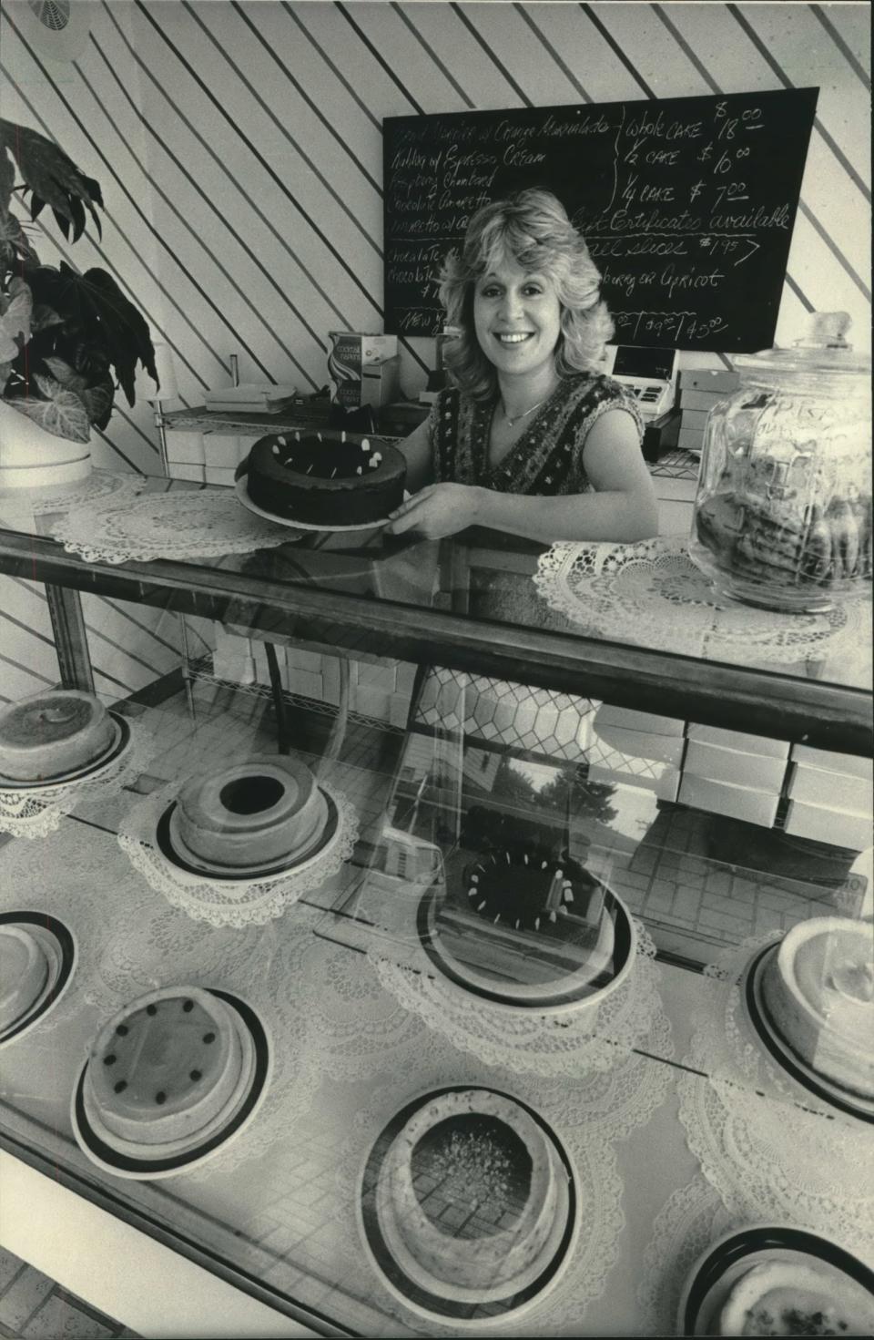 Suzy Strothmann presents her Chocolate Amaretto cheesecake at her shop, Suzy's Cream Cheesecakes at 5901 W. Vliet St., in 1984.