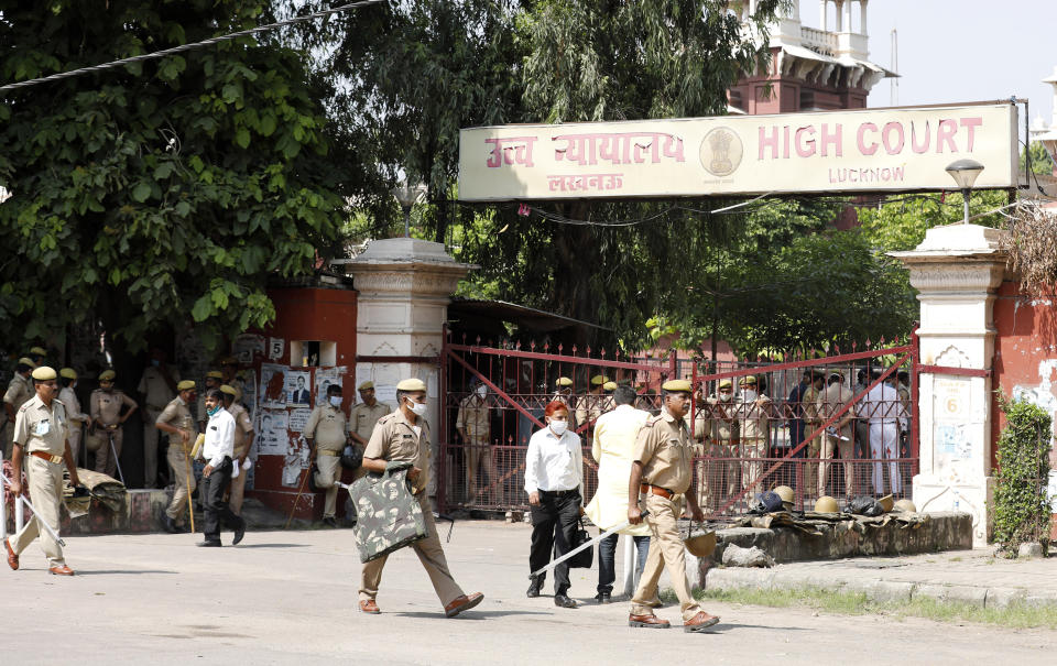 POlicemen stand guard outside a court in Lucknow, India, Wednesday, Sept. 30, 2020. An Indian court on Wednesday acquitted all 32 accused, including four senior leaders of the ruling Hindu nationalist Bharatiya Janata Party, in a 1992 attack and demolition of a 16th century mosque that sparked Hindu-Muslim violence that left some 2,000 people dead. (AP Photo/Rajesh Kumar Singh)