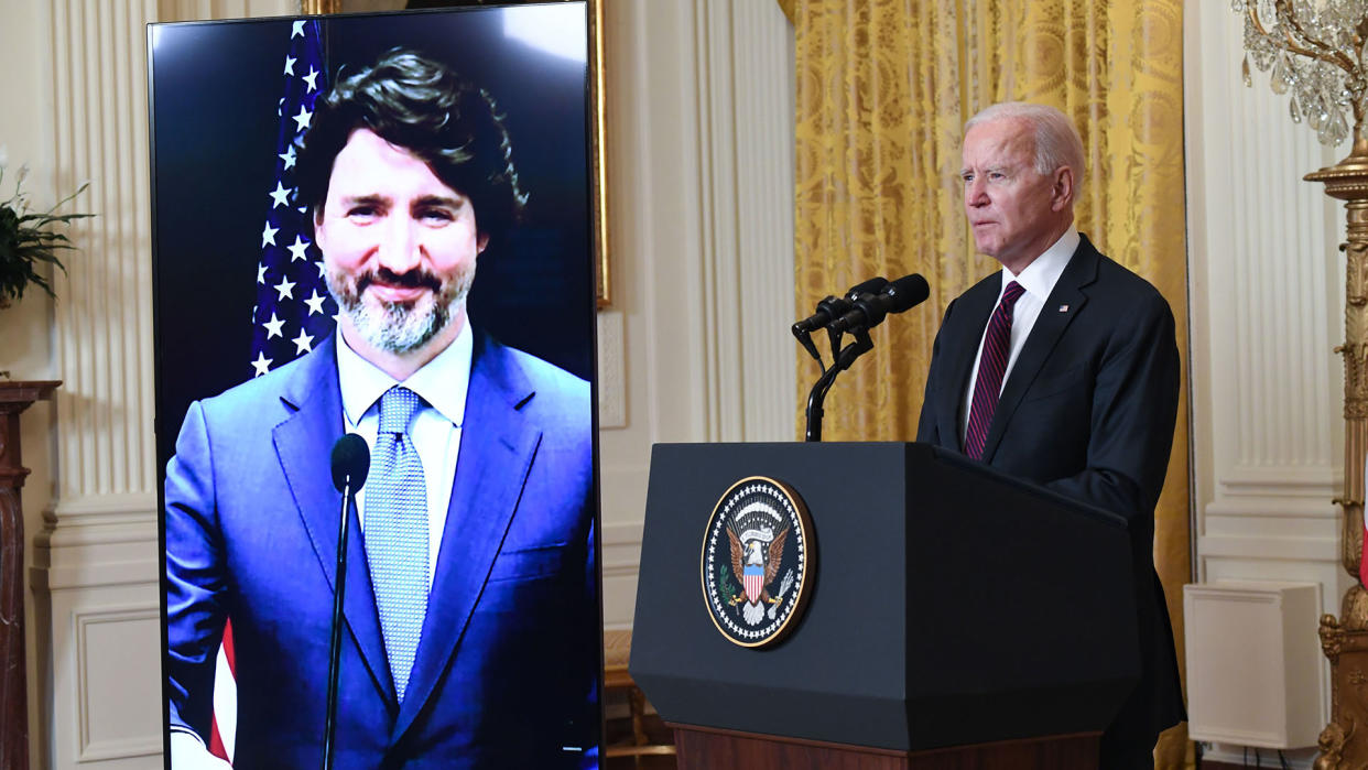 US President Joe Biden and Canadian Prime Minister Justin Trudeau (on screen) speak to the media after holding a virtual bilateral meeting in the East Room of the White House in Washington, DC, February 23, 2021. - President Joe Biden declared Canada and the United States best friends Tuesday, while Prime Minister Justin Trudeau called the friendship 