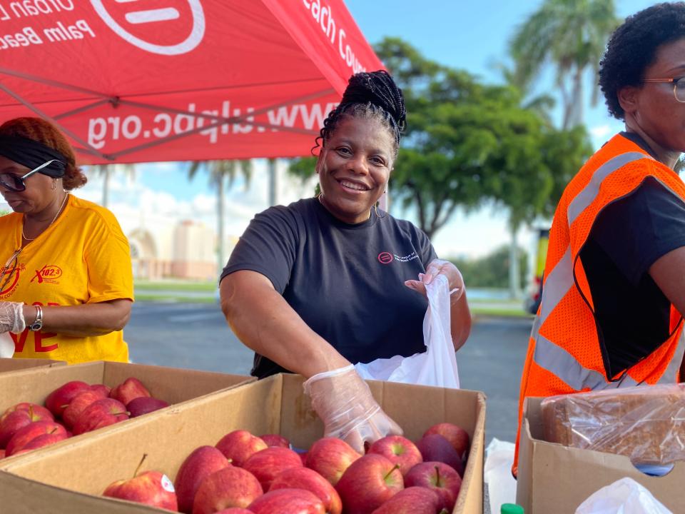 Angela Powell of West Palm Beach packs bags of fresh produce Saturday for needy families during the Urban League of Palm Beach County's second annual Summer Back-to-School Food Drive.