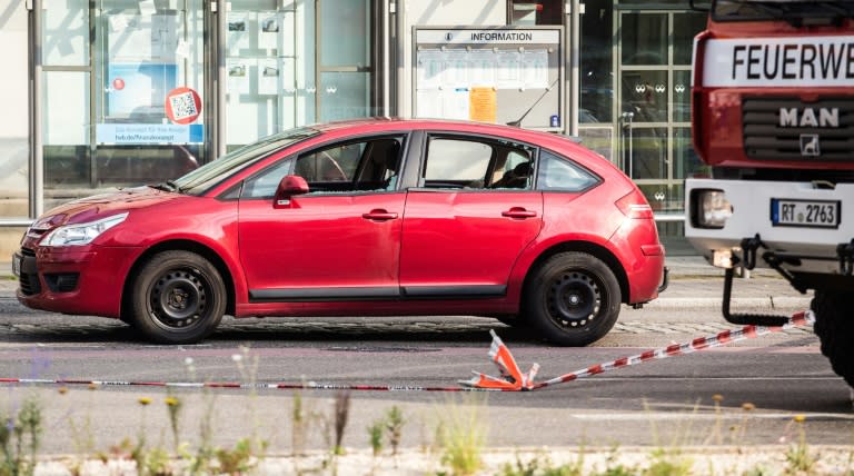 A damaged car is seen near the site where a Syrian asylum-seeker killed a woman and injured two people with a machete, on July 24, 2016 in Reutlingen, southern Germany