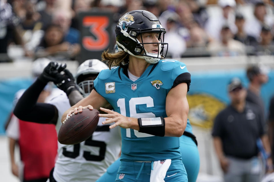 Jacksonville Jaguars quarterback Trevor Lawrence passes against the Las Vegas Raiders in the first half of an NFL football game Sunday, Nov. 6, 2022, in Jacksonville, Fla. (AP Photo/John Raoux)