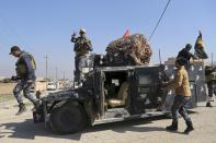 Iraqi Federal police deploy after regaining control of the town of Abu Saif, west of Mosul, Iraq, Wednesday, Feb. 22, 2017. Iraq's government-sanctioned paramilitary forces, made up mainly of Shiite militiamen, have launched a new push to capture villages west of the city of Mosul from Islamic State militants.(AP Photo/Khalid Mohammed)