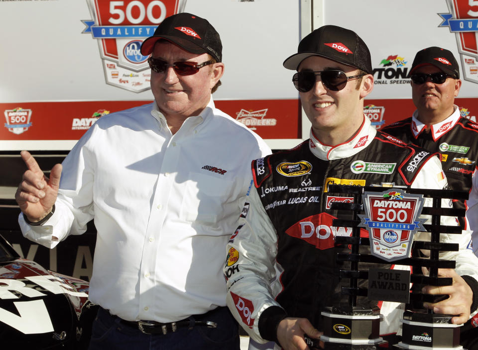 Austin Dillon, right, holds up the pole award with car owner and grandfather Richard Childress after qualifying for the pole position in the Daytona 500 NASCAR Sprint Cup Series auto race at Daytona International Speedway in Daytona Beach, Fla., Sunday, Feb. 16, 2014. (AP Photo/Terry Renna)