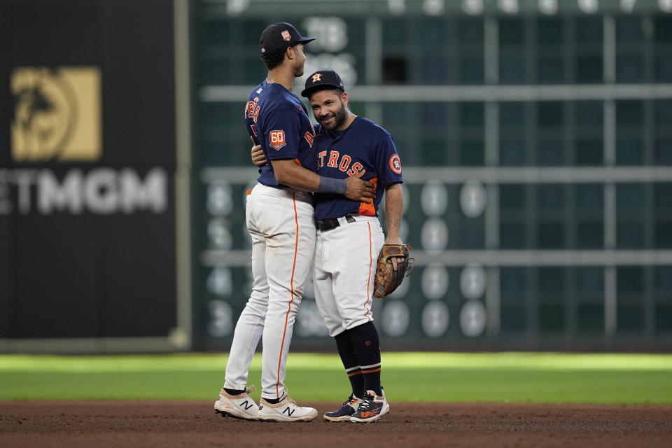 Houston Astros' Jose Altuve, right, and Jeremy Pena hug after a baseball game against the Baltimore Orioles Sunday, Aug. 28, 2022, in Houston. The Astros won 3-1. (AP Photo/David J. Phillip)