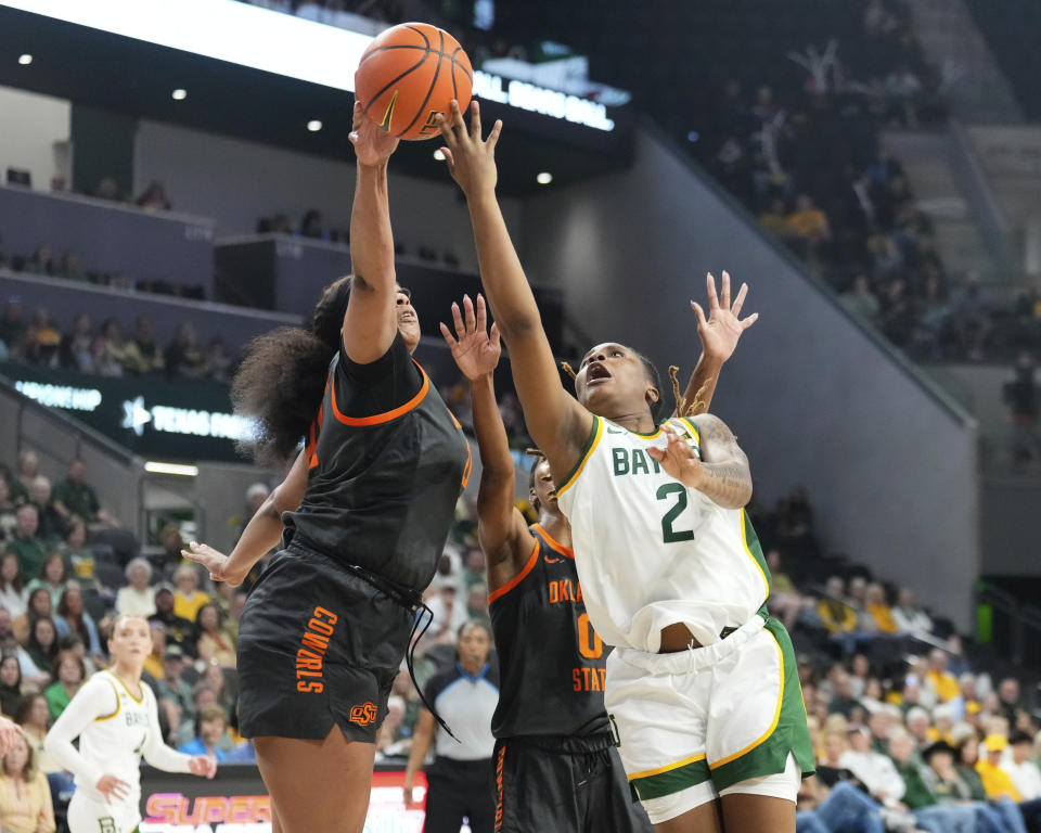 Baylor guard Yaya Felder attempts a shot over Oklahoma State center Hannah Gusters in the first half of an NCAA college basketball game, Sunday, March 3, 2024, in Waco, Texas. (Chris Jones/Waco Tribune-Herald via AP)