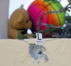 <p>A bullet hole is marked by police as a small memorial grows outside of Club Blu where two people were killed and at least 15 were wounded on July 25, 2016 in Fort Myers, Fla. (Mike Carlson/Getty Images)</p>