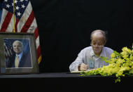 <p>Pham Minh Chuc, an 81-year-old retiree, writes a book of condolences for Senator John McCain in Hanoi, Vietnam, Monday, Aug. 27, 2018. People in Vietnam are paying their respects to U.S. Sen. John McCain who was held as a prisoner of war in Vietnam and later was instrumental in bringing the wartime foes together. McCain died on Saturday. (Photo: Tran Van Minh/AP) </p>