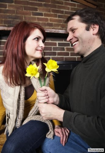 man giving woman flowers